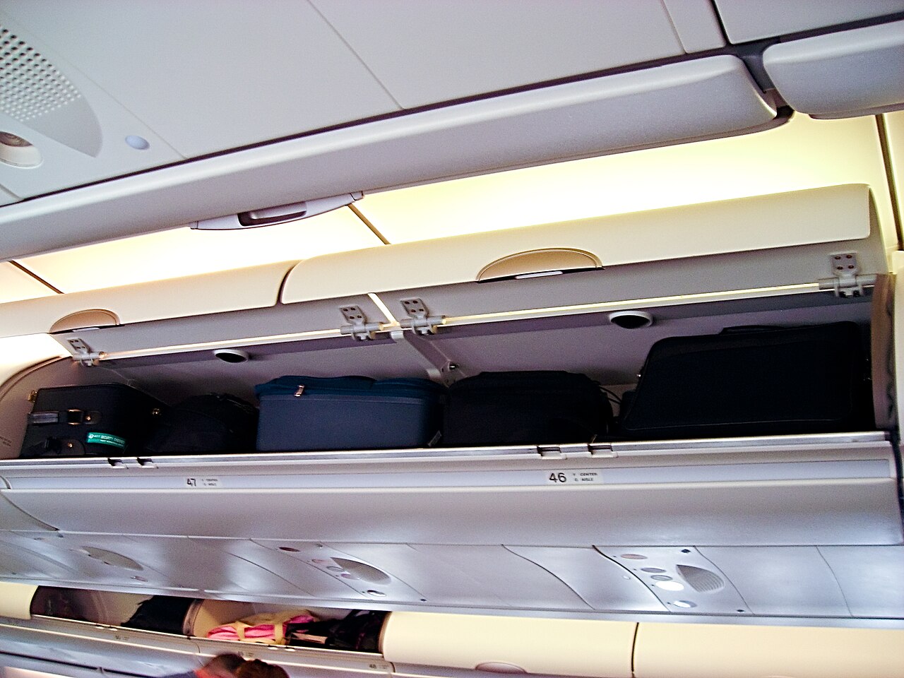 home 2 5 Key Reasons Flight Attendants Touch Overhead Bins During